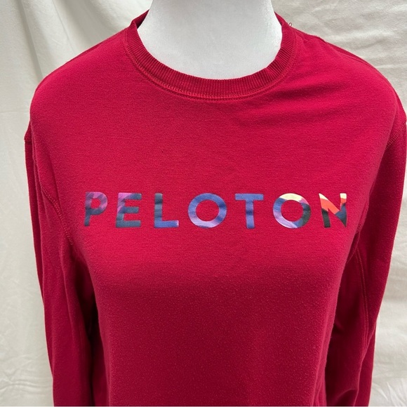 Peloton cranberry colored lightweight sweatshirt with multi-color brand name. - Picture 1 of 8